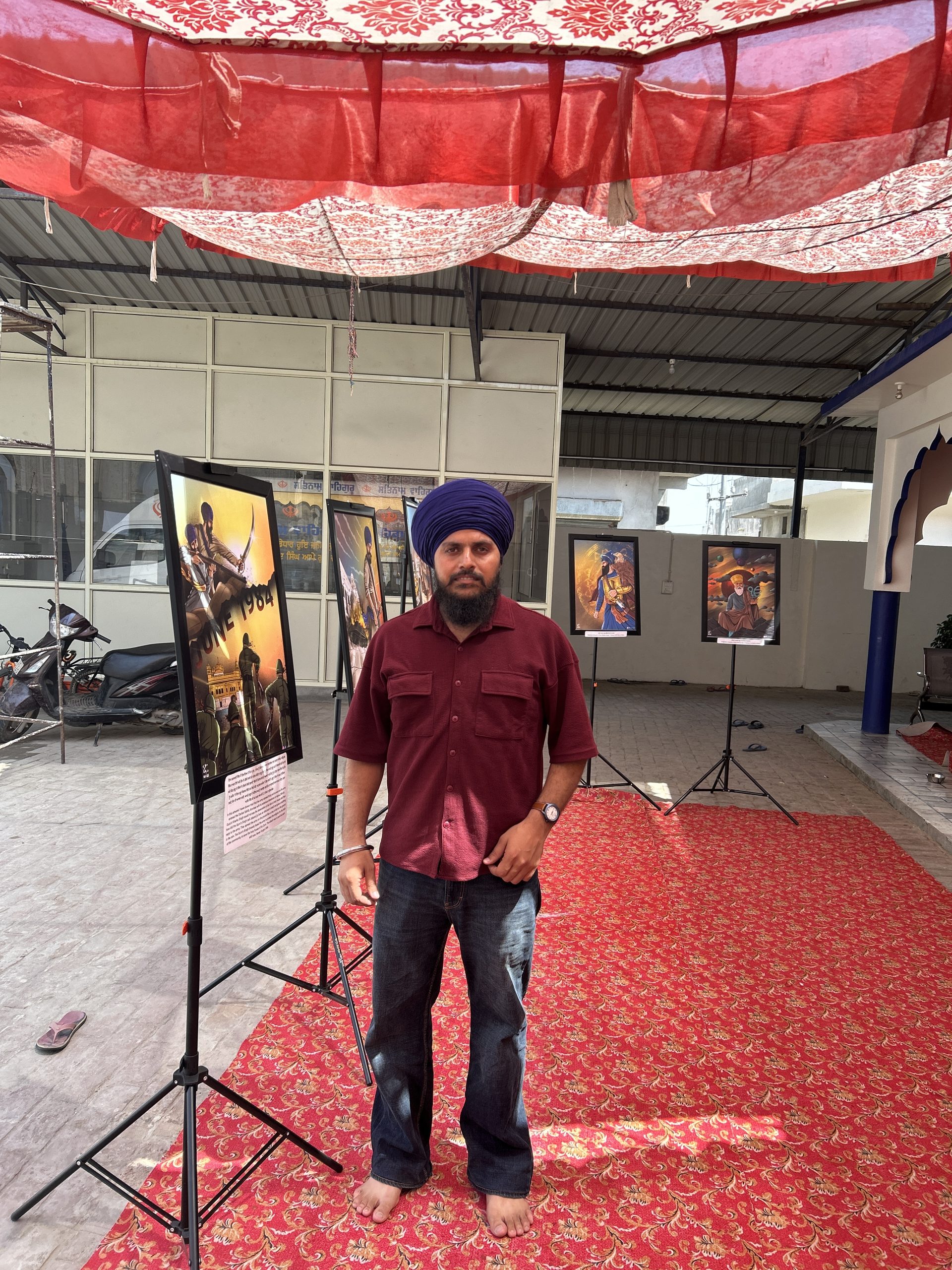 A Sikh art exhibition set up on display stands, ready for sangat