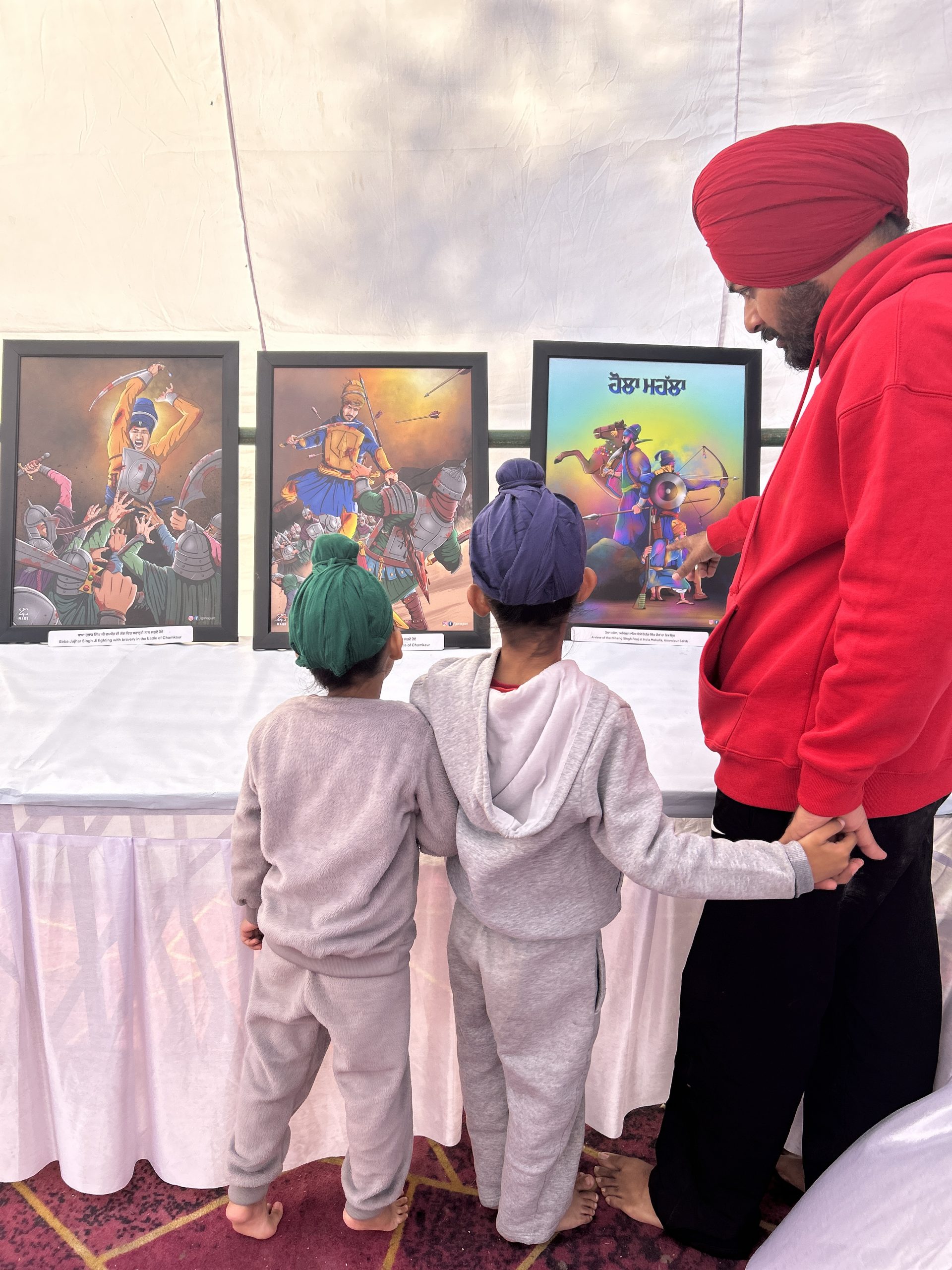 Children viewing Sikh history artworks at an exhibition