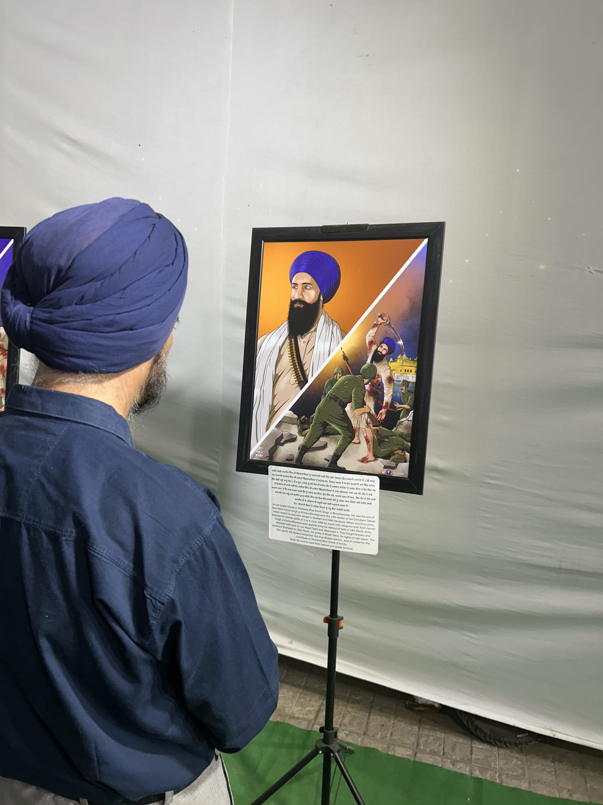 A visitor reading the history beside an artwork during a guided walk